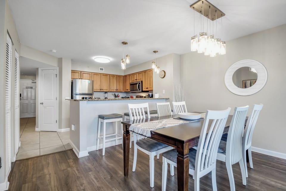 Gather around this elegant dining table for memorable meals, while the open kitchen invites you to cook together in comfort.