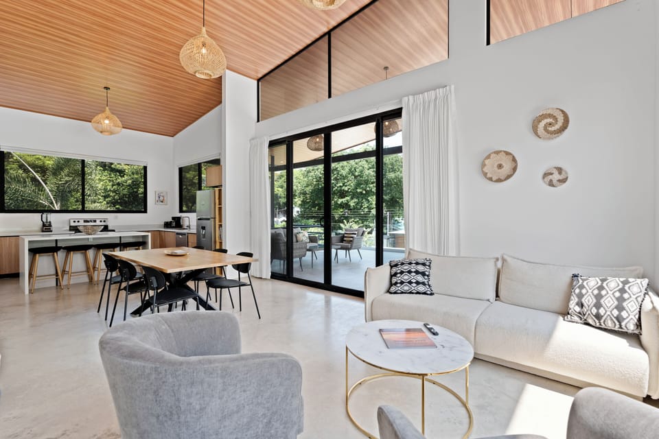 Upper floor open concept living area and kitchen with sliding doors to balcony.