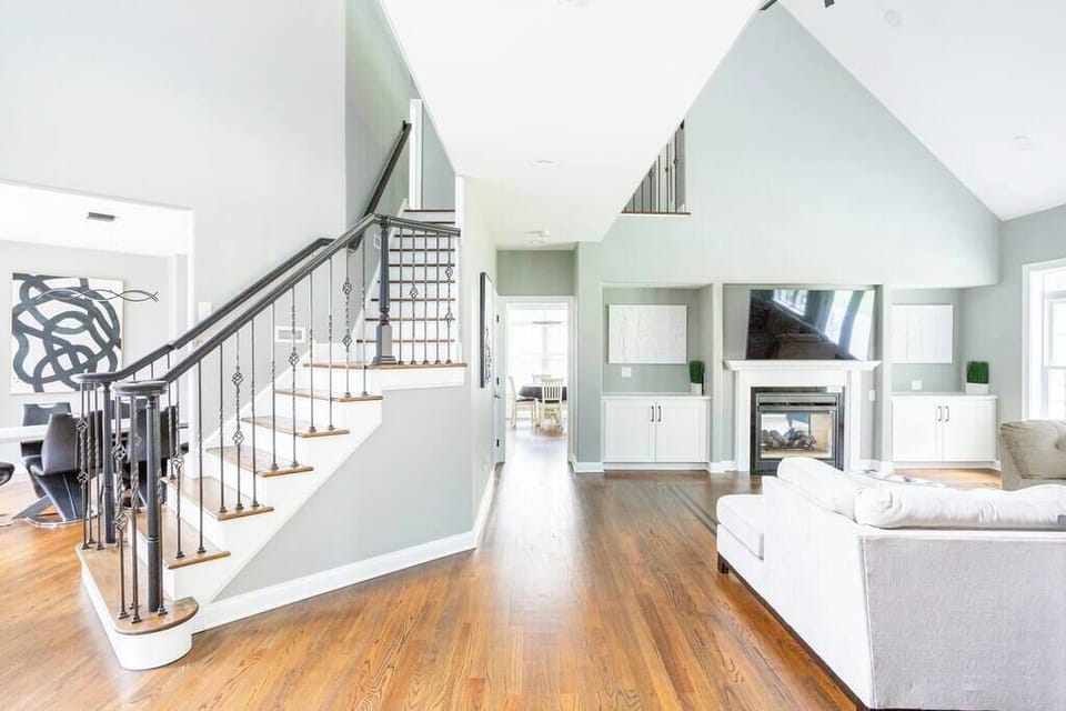 Living room and stairs to 2nd floor, 4k TV with Roku and gas double sided fire place