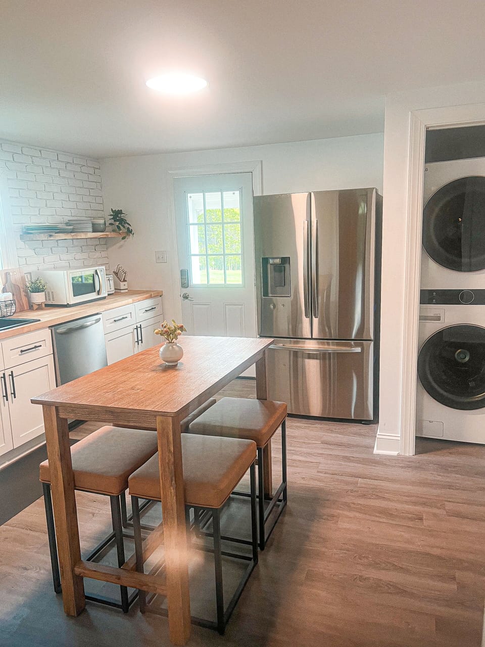 New stainless steel appliances in the kitchen and a washer and dryer 