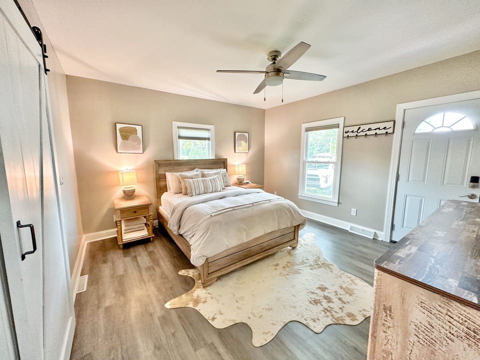 Cozy and comfortable King bedroom with a 65 inch TV, two nightstands and dresser