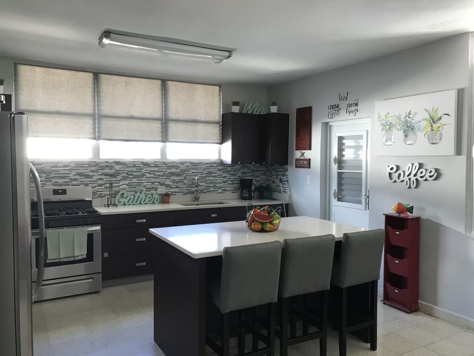 Gorgeous kitchen open space with 3 arm chairs and a coffee table for gathering