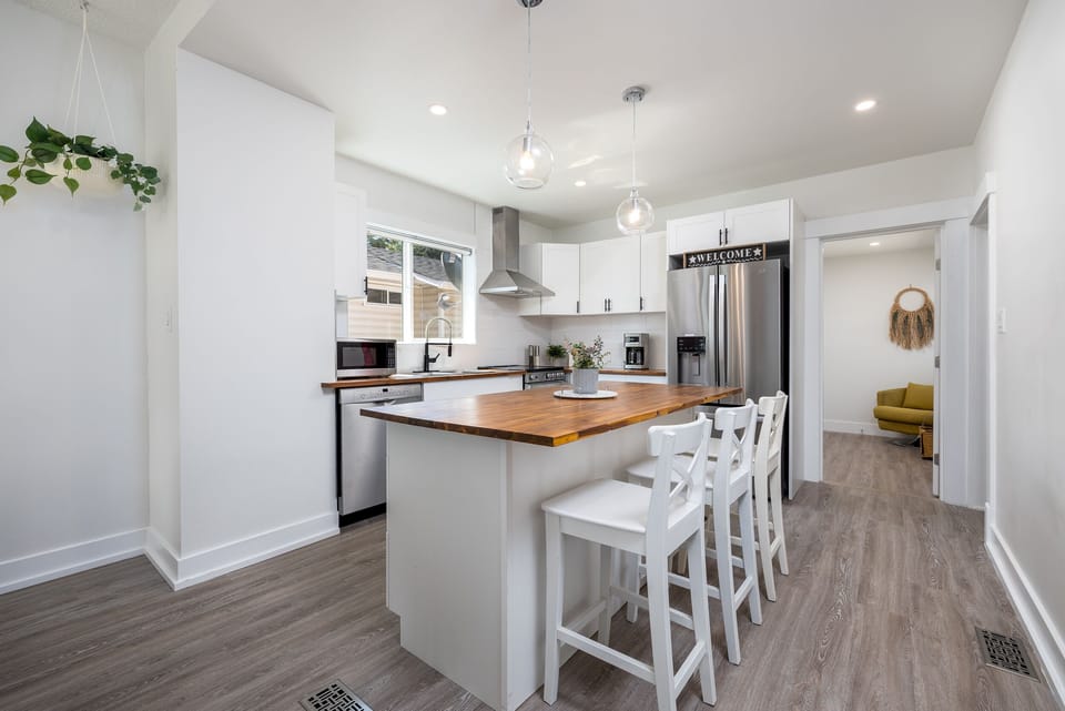 Butcher bloc counter with bar stools provide an easy place for breakfast 