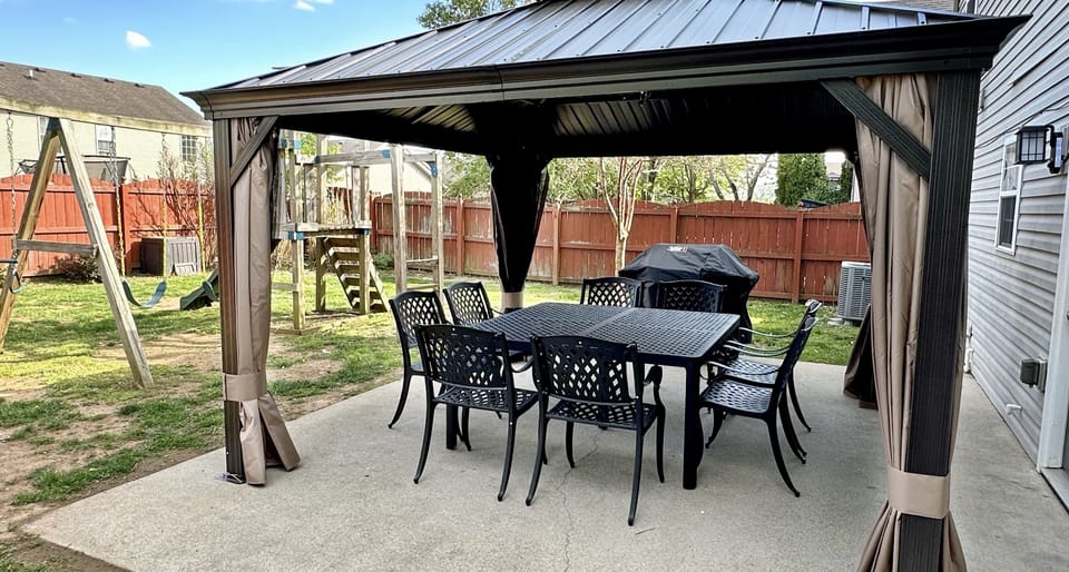 Covered outdoor dining for 8, BBQ grill, playset, fenced backyard