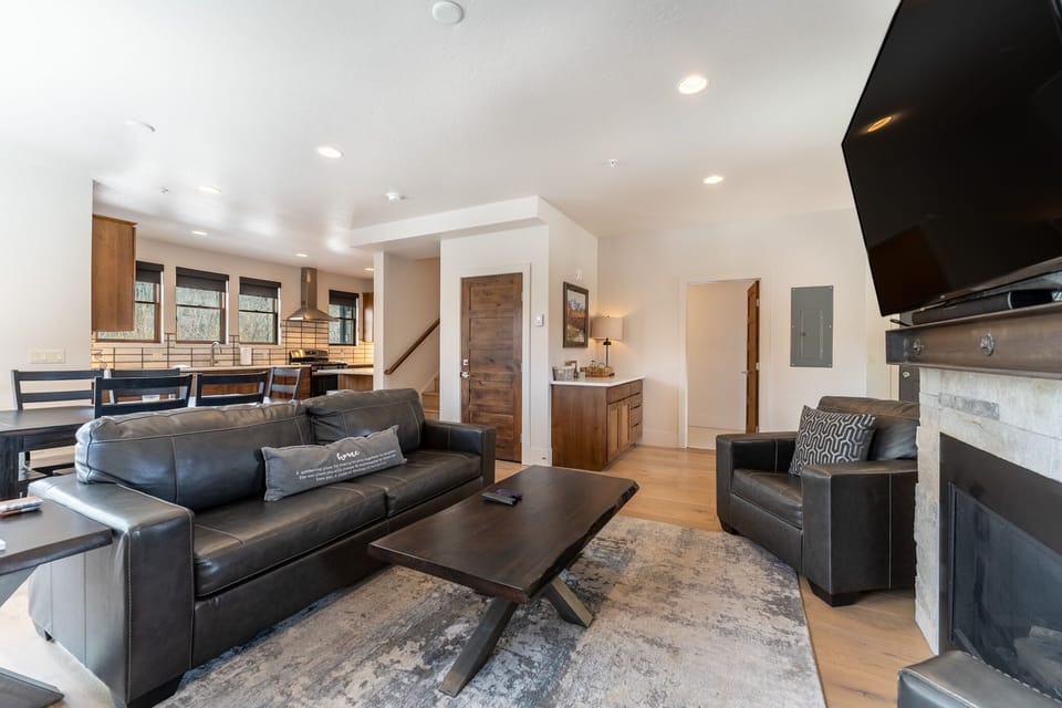 Living area offering a smart TV, cozy furnishings and a gas fireplace.