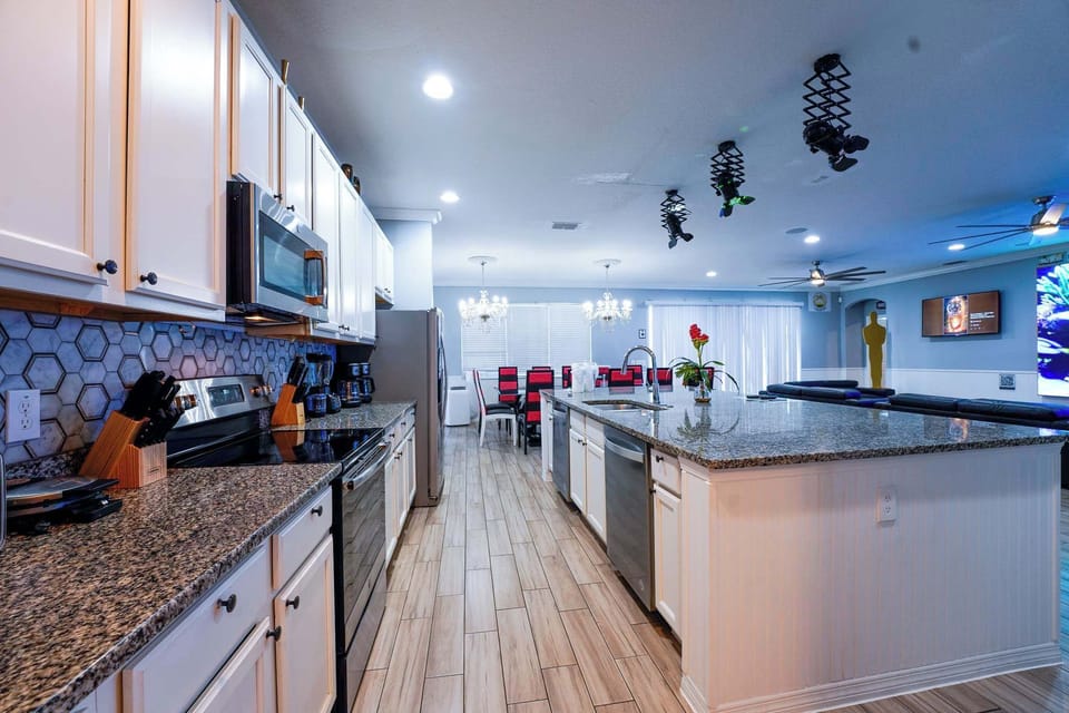 Experience culinary delight in this expansive kitchen with modern amenities and a chic dining area perfect for gatherings.