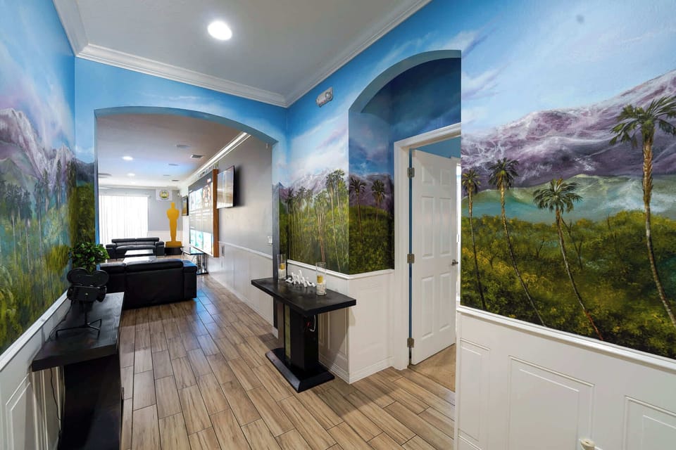 Experience cinematic luxury in this vibrant living area with stunning murals and plush seating, perfect for relaxation and entertainment.