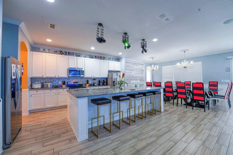 Experience culinary delight in this expansive kitchen with a stylish dining area, perfect for large gatherings.