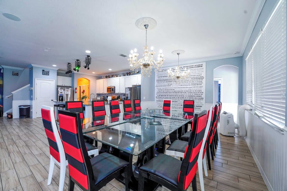 Host memorable dinners in this elegant dining room with seating for 12, featuring chic chandeliers and modern decor.