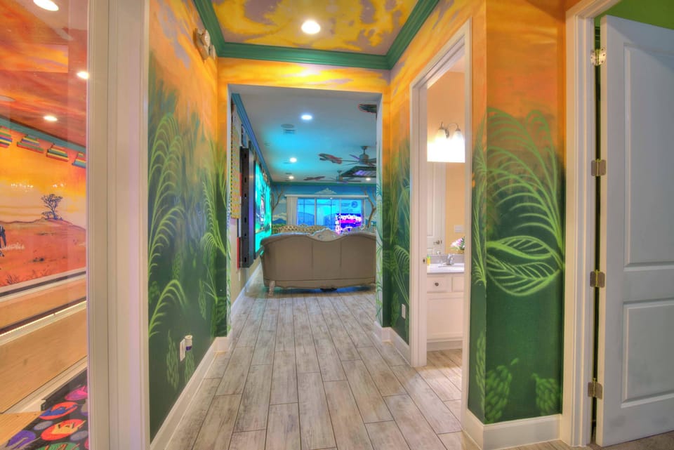 Step into a vibrant world with stunning murals and enjoy the thrill of an in-house bowling alley in this unique game room.