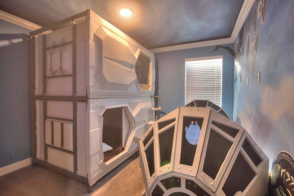 Explore the galaxy in this space-themed room with unique bunk beds and cosmic decor, perfect for a fun and adventurous stay.