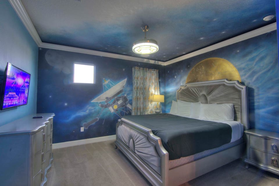 Explore the universe from your bed in this space-themed room, complete with cosmic murals and modern amenities.