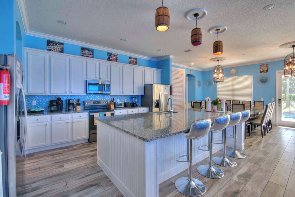 Enjoy cooking in this expansive kitchen with a large island, modern appliances, and ample seating for family gatherings.