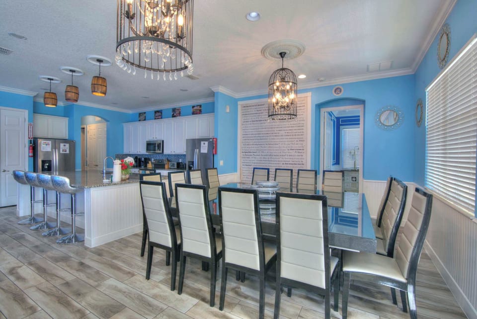 Elegant dining space perfect for large gatherings, featuring a modern kitchen and stylish decor.