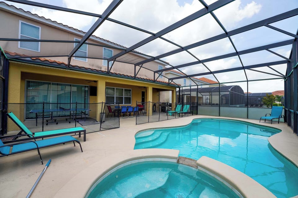 Relax in your private screened pool and hot tub oasis, complete with a spacious patio and vibrant dining area.