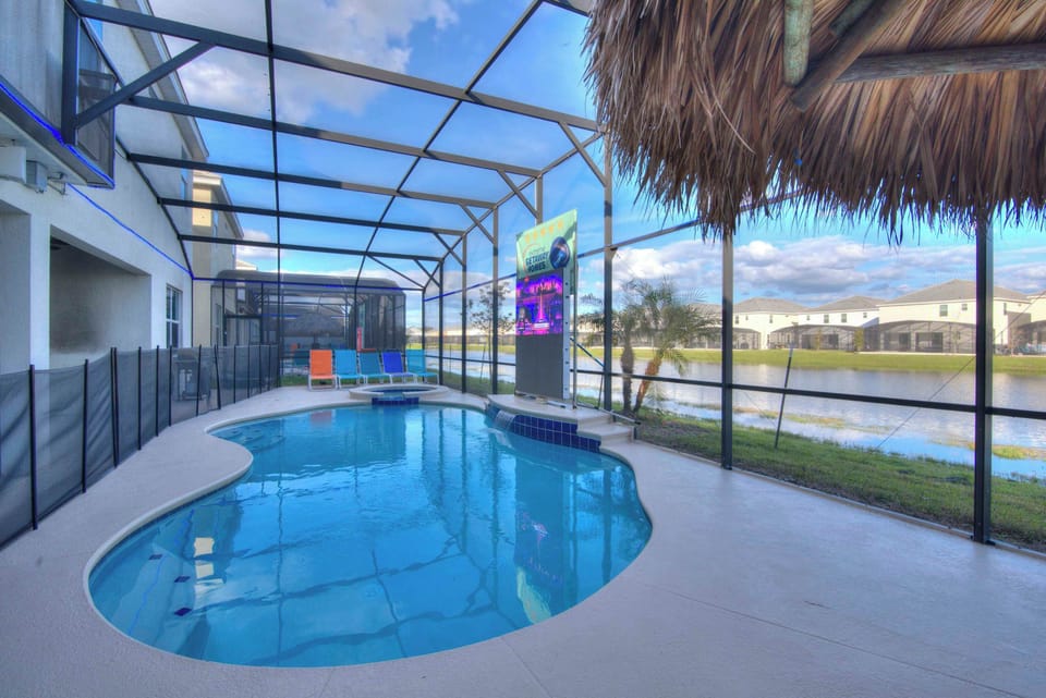 Relax by the private pool with serene pond views and vibrant seating, perfect for unwinding in style.