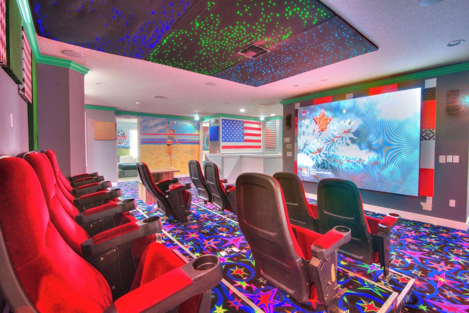 Experience cinematic magic in your private home theater with plush seating and a dazzling starry ceiling.