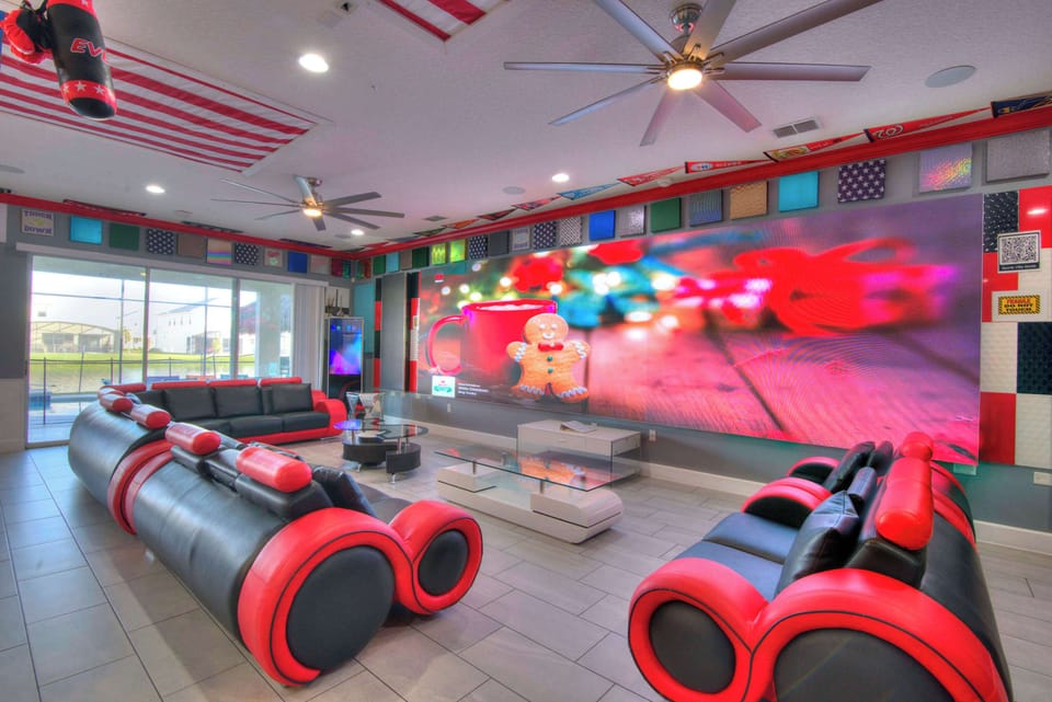 Experience ultimate entertainment in this vibrant game room with a massive screen and stylish seating, perfect for group fun.
