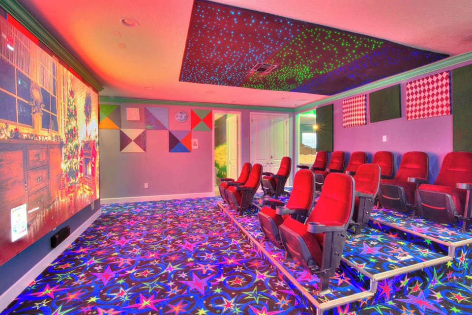 Experience movie nights in your private theater with plush seating and a starry ceiling for a magical atmosphere.
