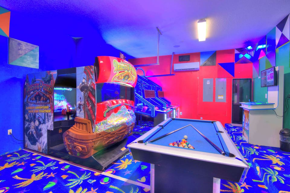 Experience endless fun in your private game room with arcade games and a pool table, perfect for entertaining guests.