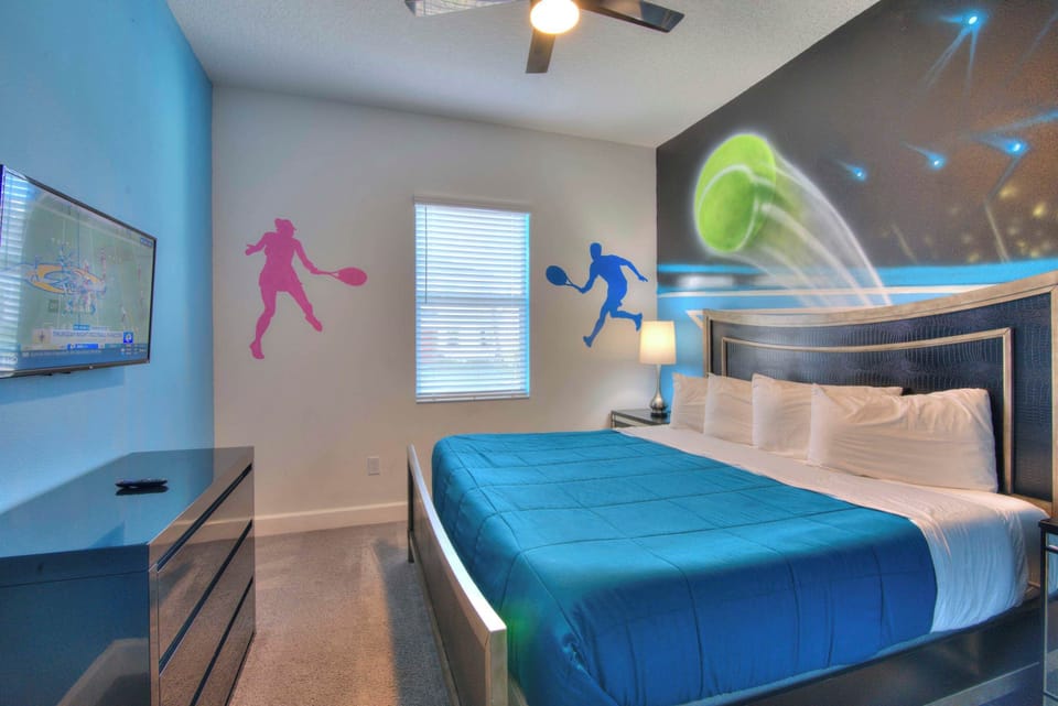 Enjoy a sporty stay in this vibrant bedroom with a king-size bed and sports-themed decor.