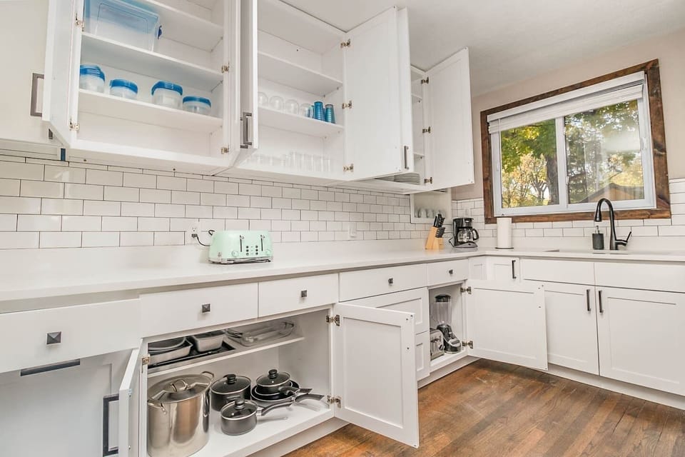 Cook meals in the newly updated kitchen. Kitchen includes nearly any basic cookware you would need: pots & pans, utensils, plates/bowls/cups, hand mixer, blender, mixing bowls, can opener, knives & cutting board, baking tins, glass casserole dishes.