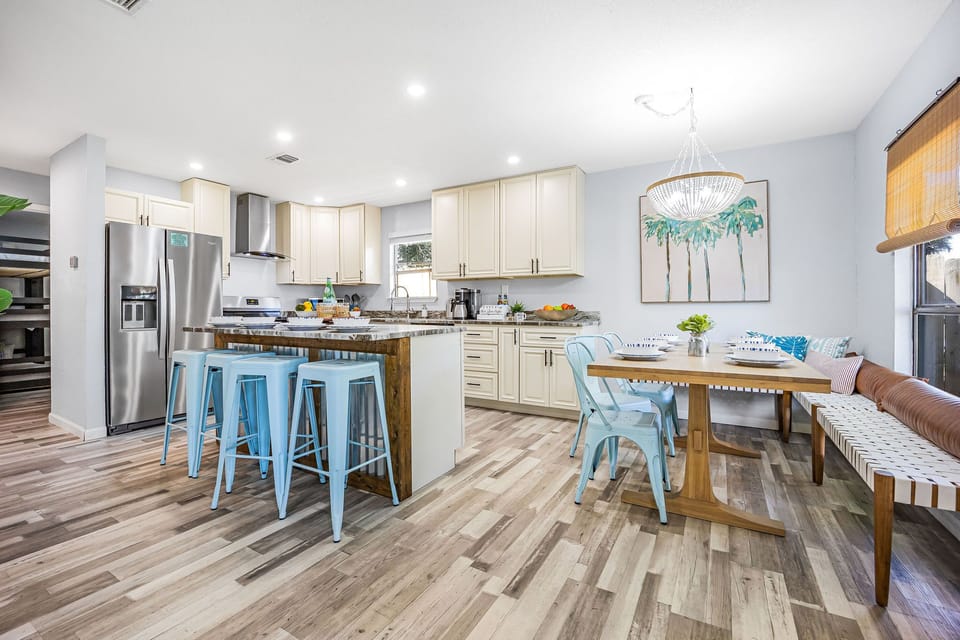 Open seating area with lots of room around dining table and island 
