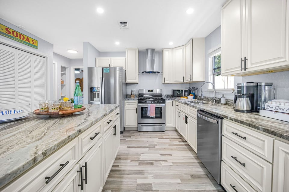 Open kitchen that is fully equipped with lots of appliances including Keurig