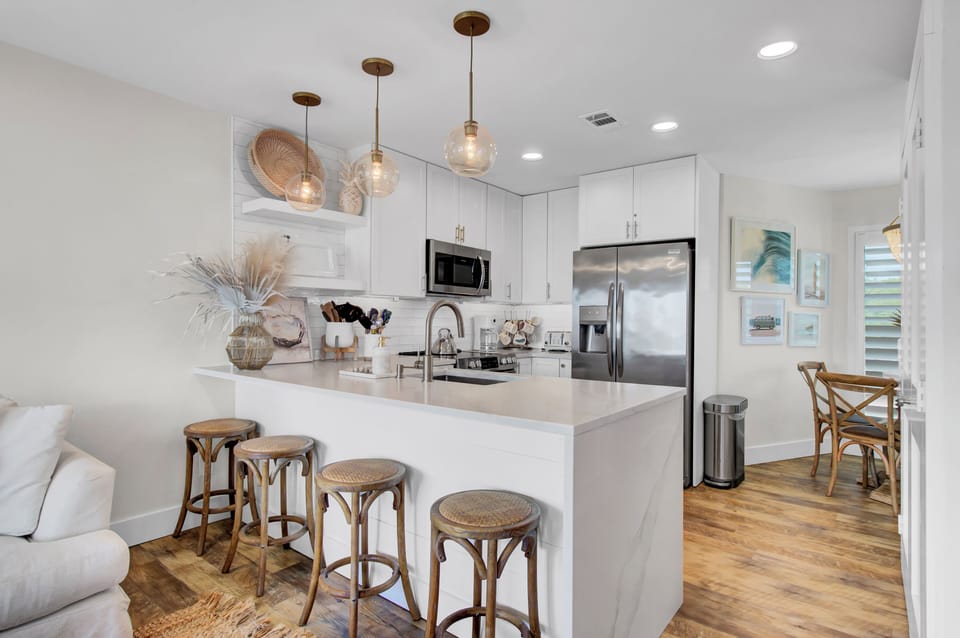 Fully equipped kitchen with barstool seating.