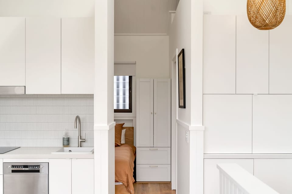 Kitchen on the left and right side of the bedroom entrance