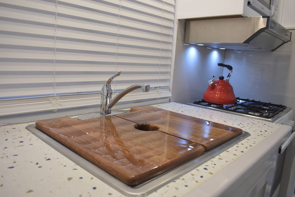 Fully equipped kitchen with gas operated stove and microwave.