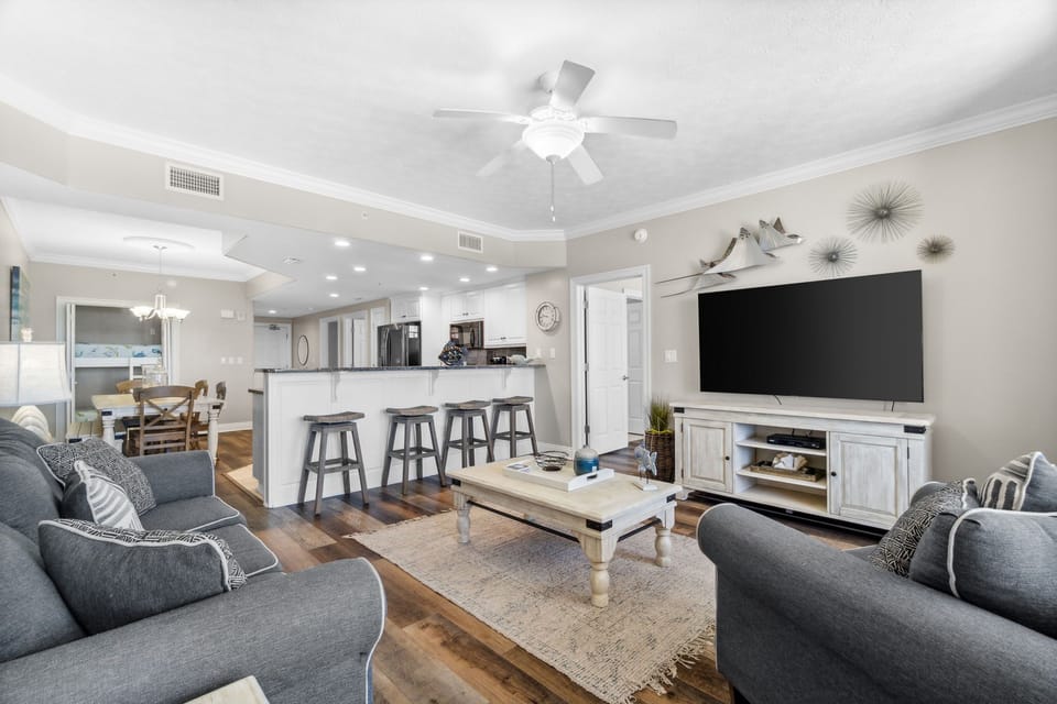 Open living & dining area w/ a ceiling fan & TV — a comfortable spot to gather.