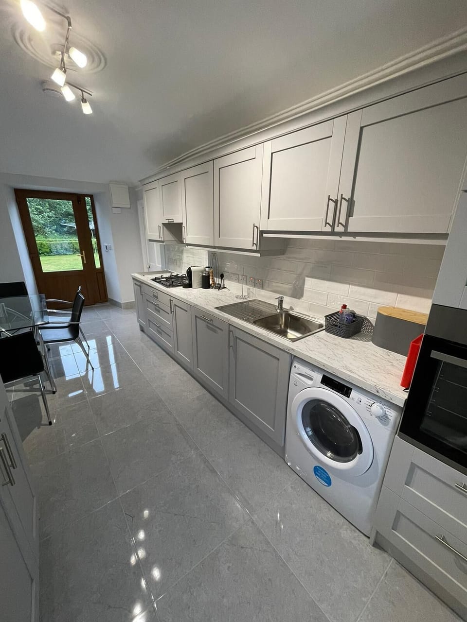 Kitchen with washer/dryer machine in the foreground