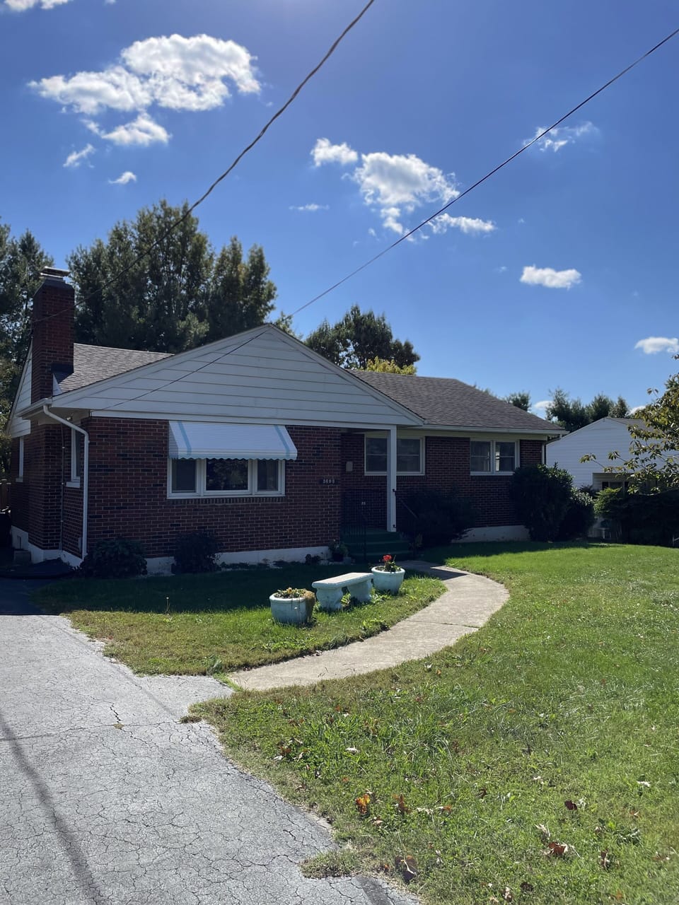 The driveway holds multiple cars and has an easy walkway to the front door. 
