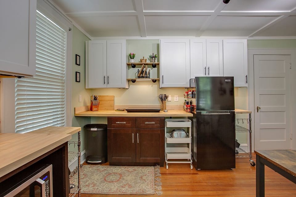 Large, modern kitchen with undercabinet lighting, cookware, olive oil & spices