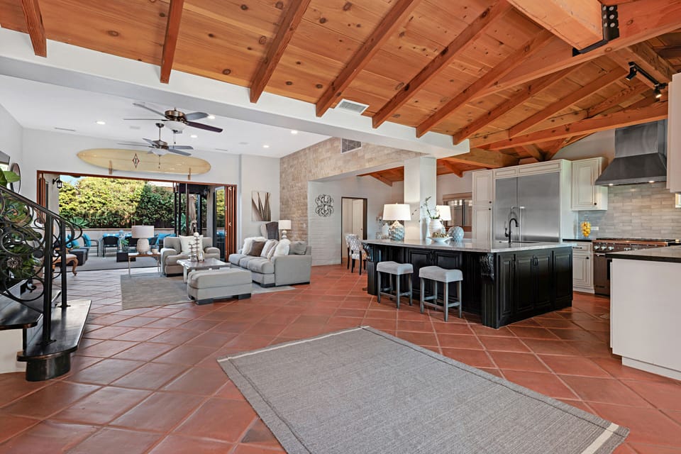 A fully equipped kitchen, dining area, and living area connect