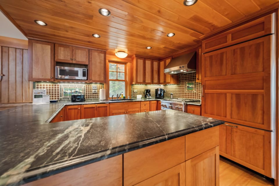Modern kitchen with stainless appliances and granite counters