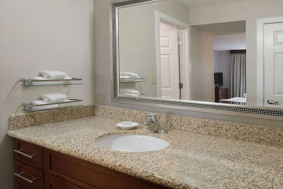 Refresh at the granite vanity with bright, easy lighting.