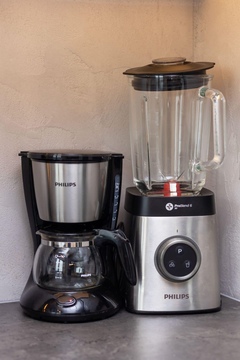 A close-up of a modern coffee machine set up on a kitchen counter, emphasizing the apartment's amenities.