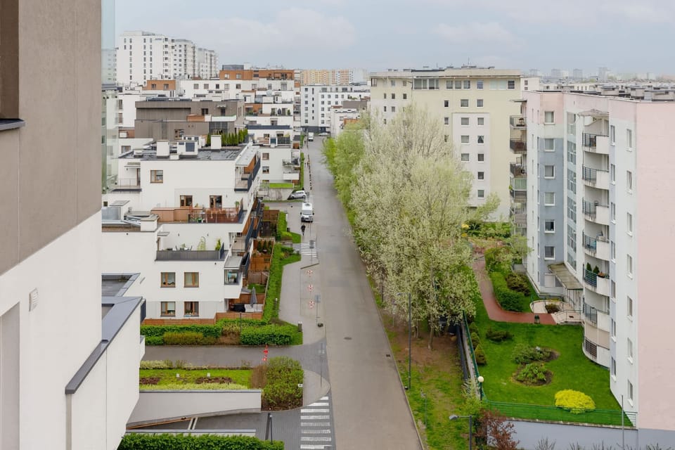 A view of the surrounding neighborhood with modern buildings and greenery.