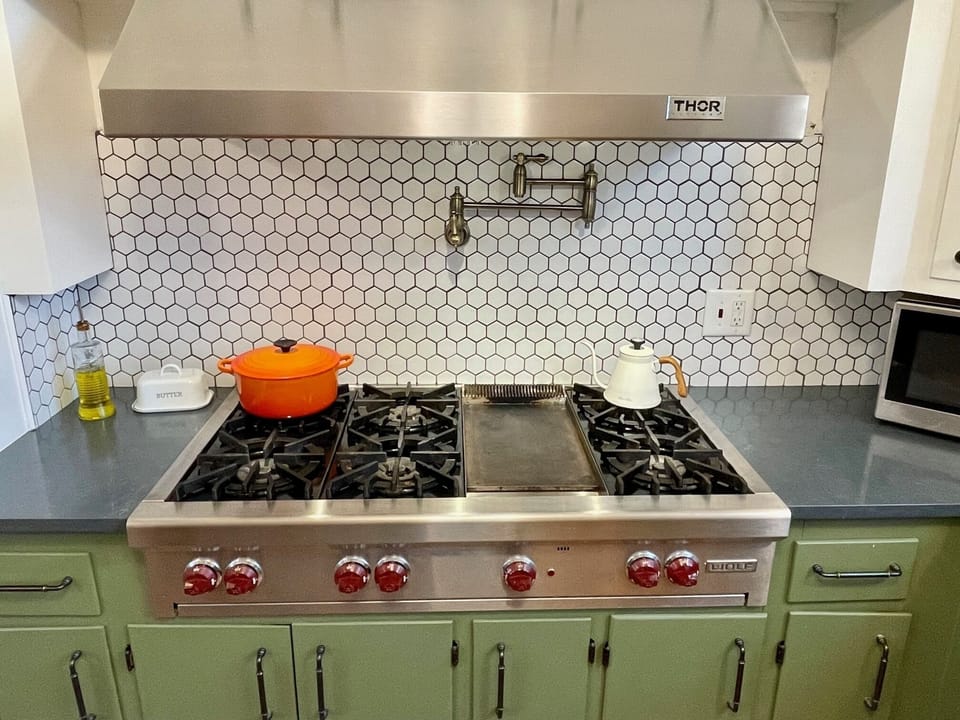 The 48 inch Wolf gas cooktop has 6 burners and a griddle.