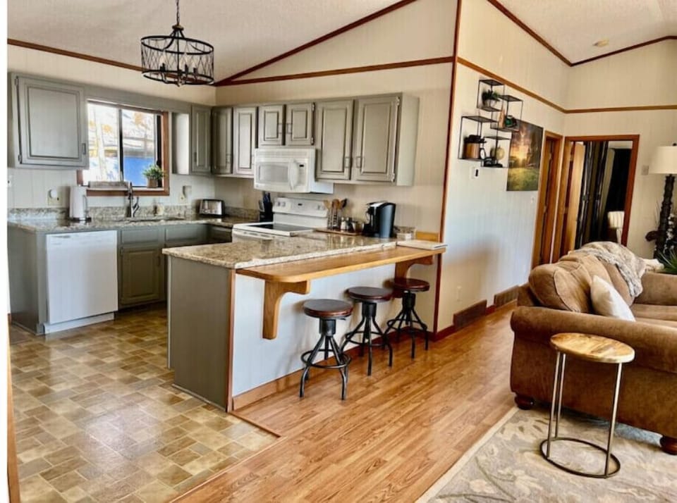 View of kitchen area with casual bar stool area 