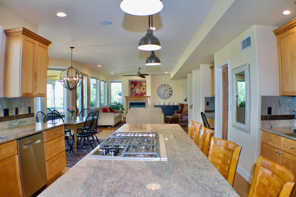 Large, well-stocked kitchen with island seating for 5 and table seating for 6.