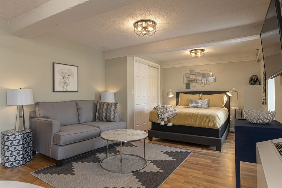 Suite featuring a queen size bed and cozy sofa 