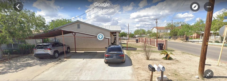 Exterior parking space on the side by Bryan St. with car port