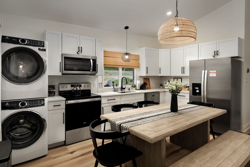 Full-sized kitchen, dining set, and in-unit laundry.