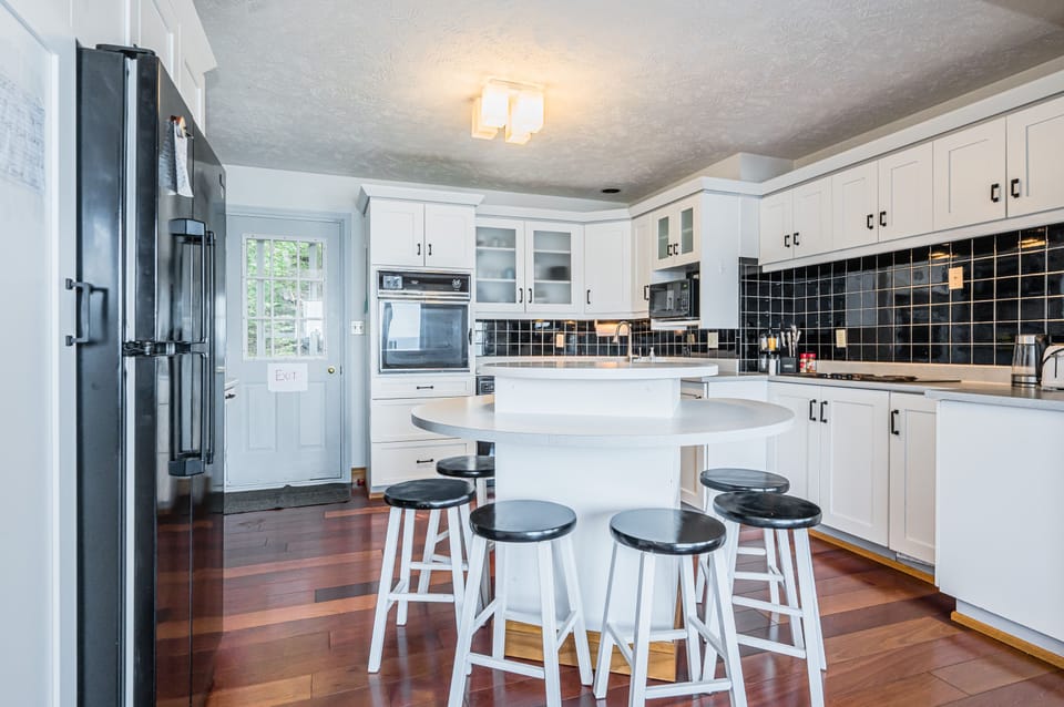The kitchen is a chef's dream, featuring modern appliances, ample counter space, and a central island that is perfect for preparing meals and entertaining guests.