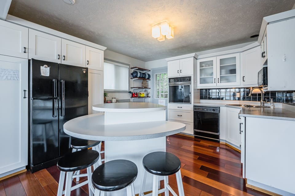 The kitchen's central island is perfect for quick family breakfasts before a day full of activities.