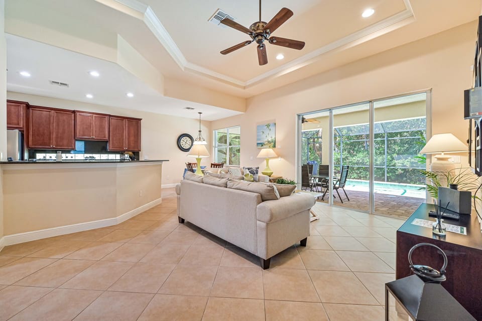 AV12731 - Family room off the kitchen with sliding door opening to the screened in pool area
