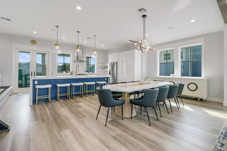 Gather around your spacious kitchen island or elegant dining table in this beautifully designed open-concept space with modern fixtures.